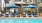 a pool with chairs and umbrellas