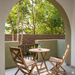 patio with a table and chairs and trees in the background