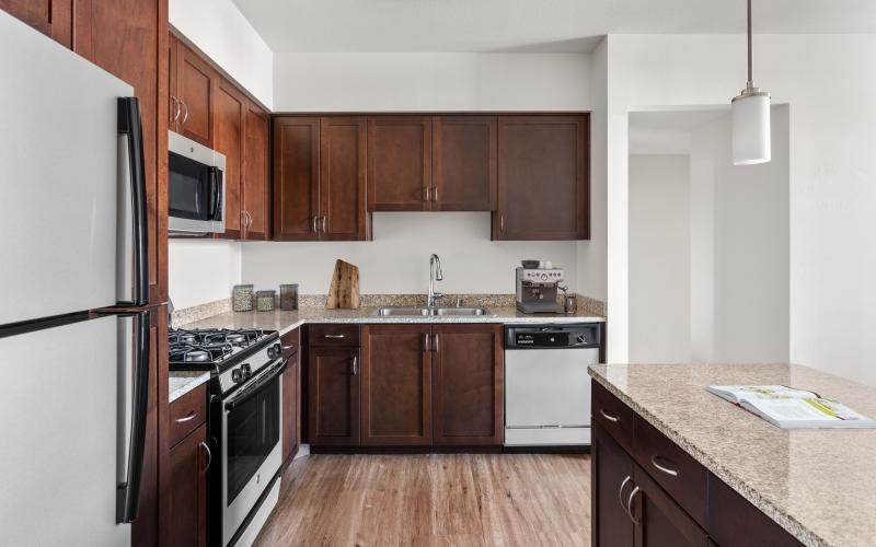 a kitchen with wooden cabinets and ample counter-space