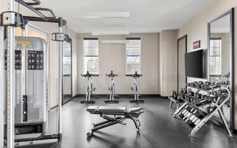 fitness center with natural lighting and plenty of equipment