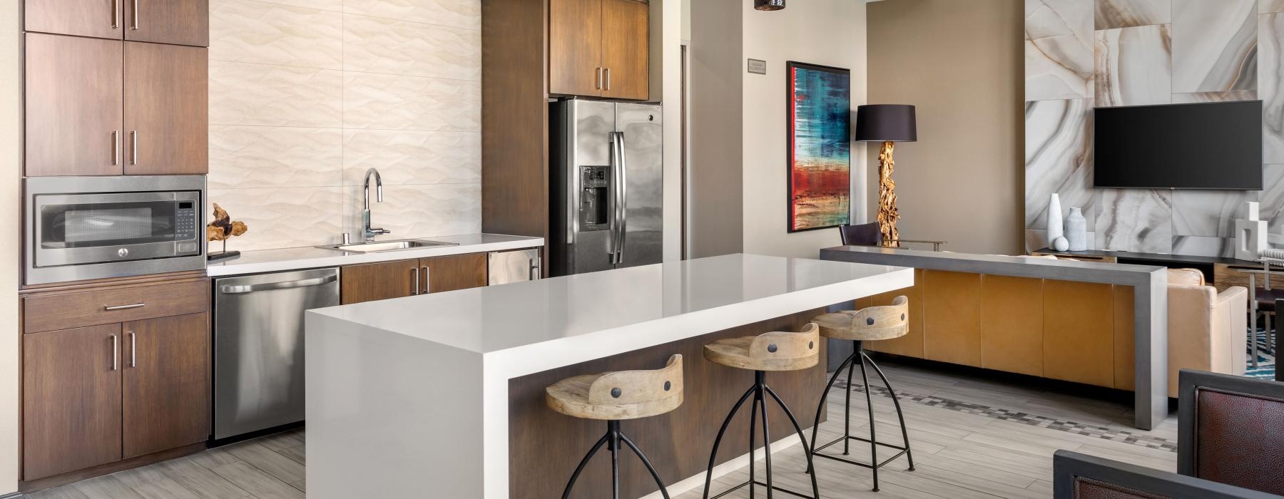 a kitchen with a bar stool and a table